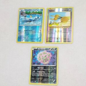 Lot of 3 Pokemon cards.